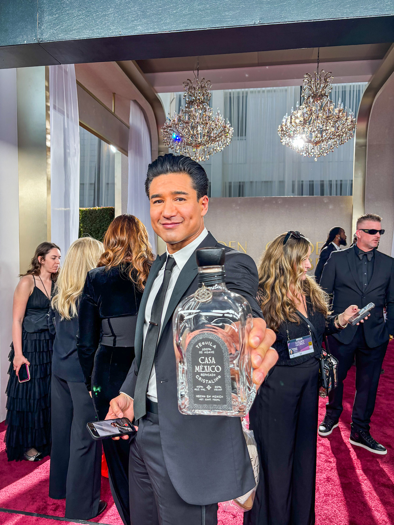 Mario Lopez holding a bottle of Casa Mexico Cristallino Tequila