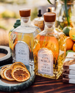 Bottles of Casa Mexico Blanco and Anejo Tequila accompanied by Orange Slices